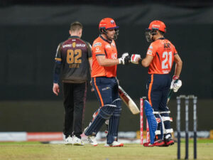 Delhi Bulls opening duo of Luke Wright and Rahmanullah Gurbaz in a mid pitch conversation during their 117 run partnership