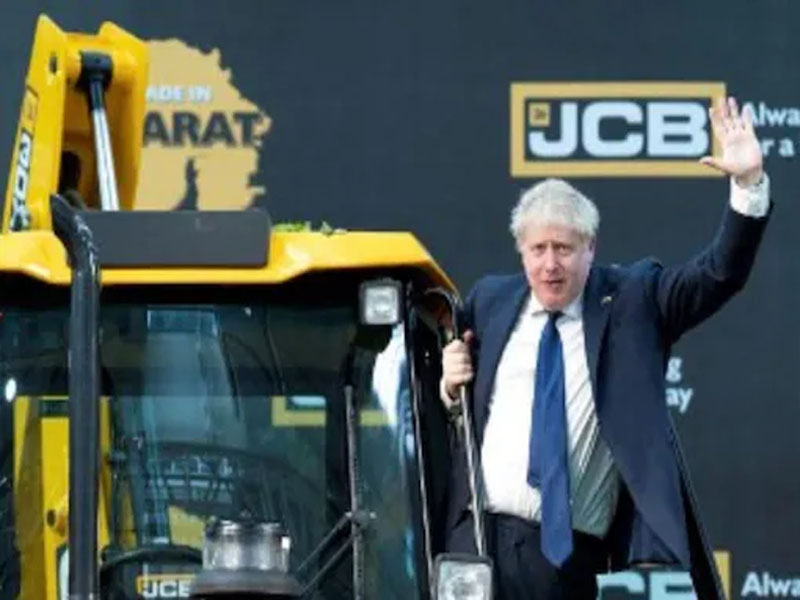 british pm hops onto iconic jcb vehicle at gujarat plant