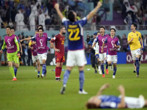 japan stun spain as both teams advance